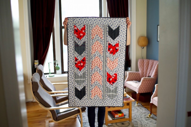 holding bow and arrows quilt